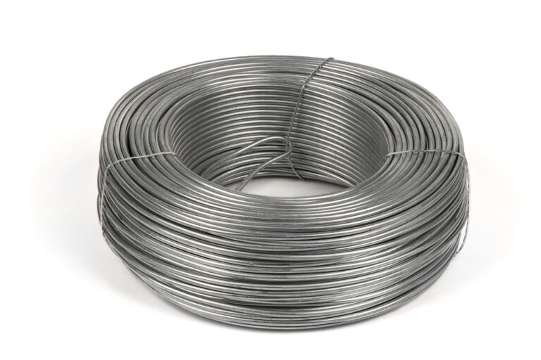 Coil of galvanized wires lying on white background. High resolution photo